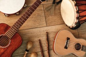 Ethnic musical instruments set: tambourine, wooden drum, brushes, wooden sticks, maracas and guitars