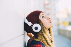 young woman outdoor listening music